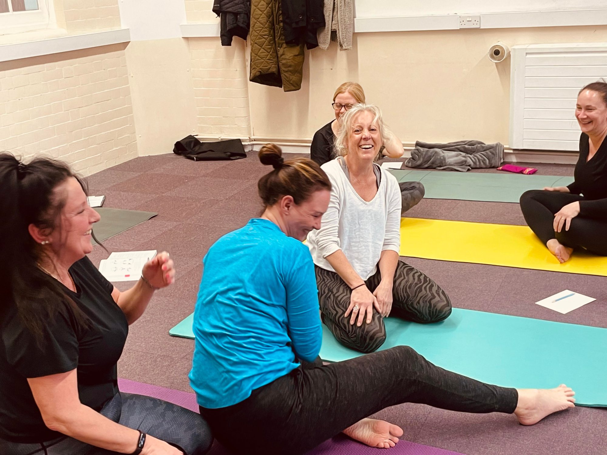 Women's yoga class laughing